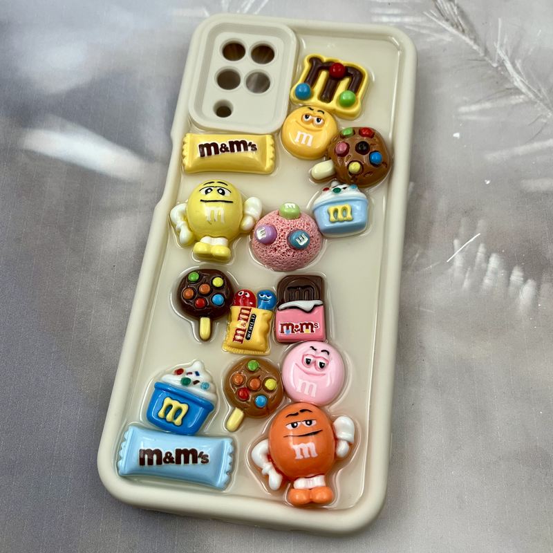 قاب گوشی Galaxy A12 / Galaxy M12 سامسونگ Solid Case سیلیکونی ضد ضربه طرح استیکر M&M محافظ لنز دار کرمی کد 86084 - Image 2